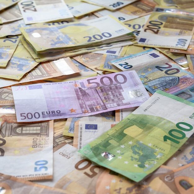 A collection of Euro banknotes representing wealth, savings, and European economy.
